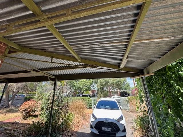 Wide underside view of an existing roofed outdoor structure and its framing