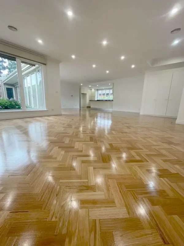Polished parquet wood floor in a large open-plan living area