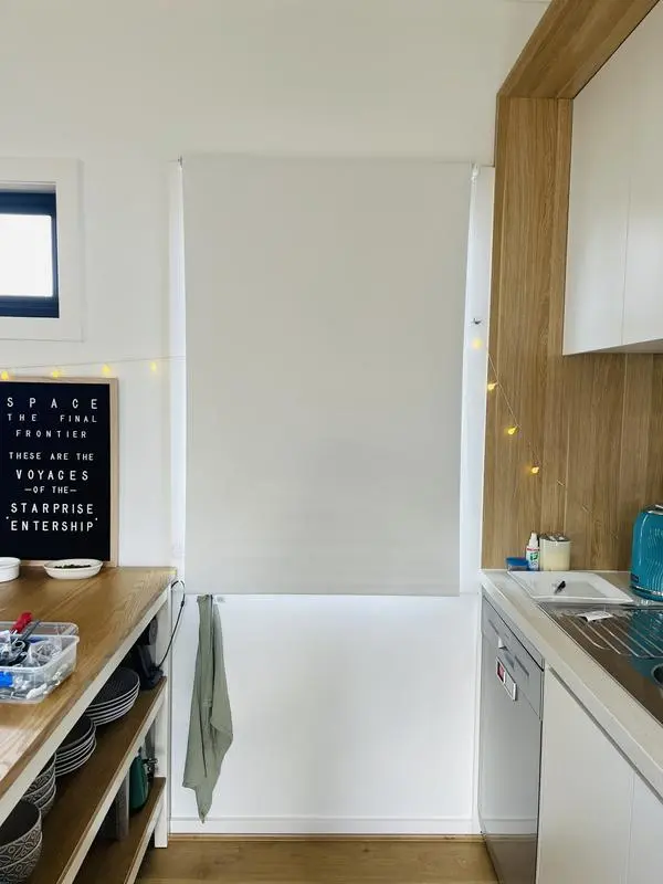 Modern galley kitchen with white cabinetry and timber-finish joinery